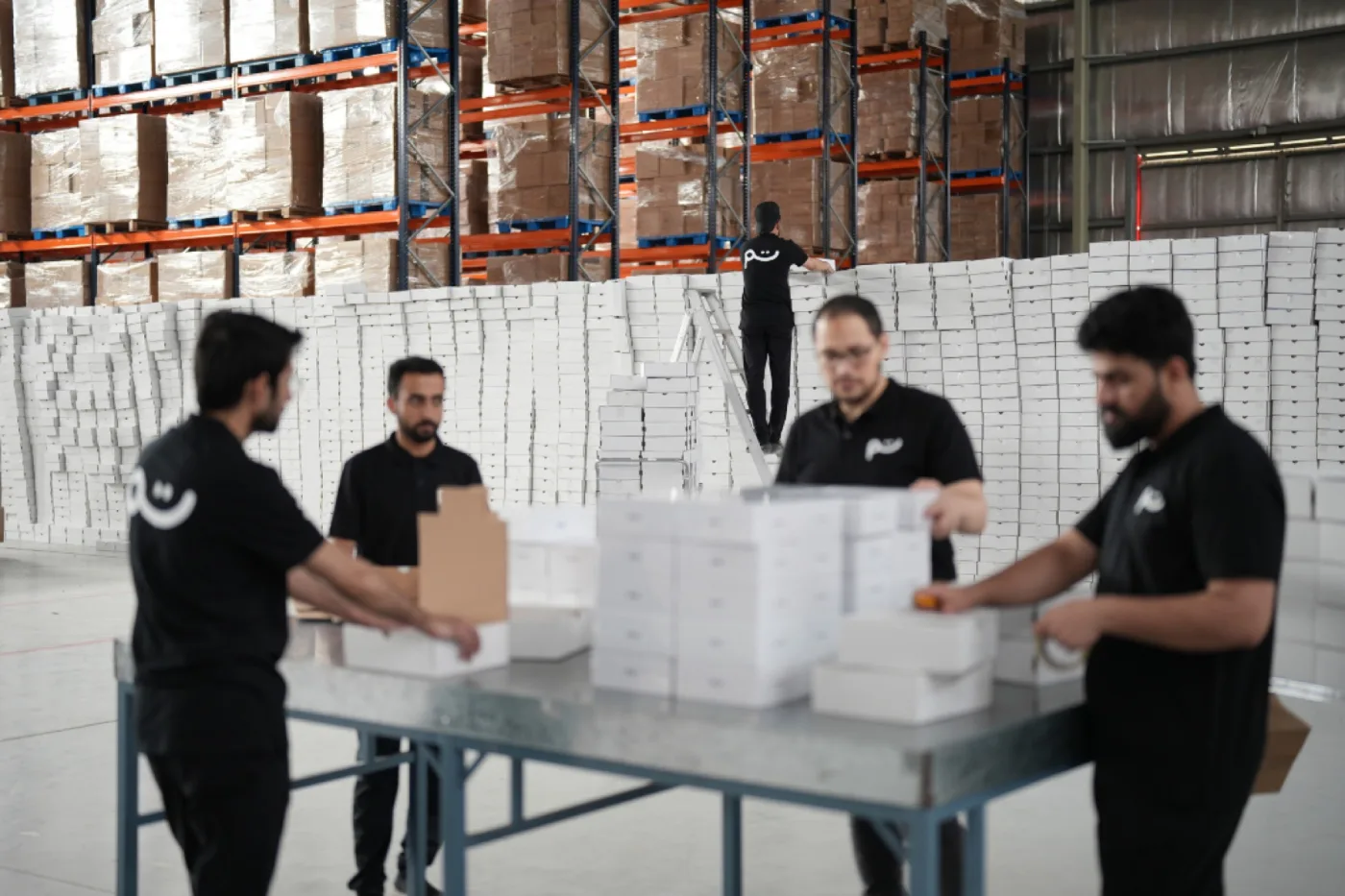 The Tamm team packing orders at the table in our warehouses